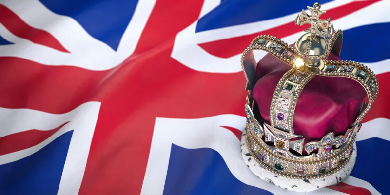 royal golden crown with jewels on british flag symbols of uk united kingdom 3d illustration