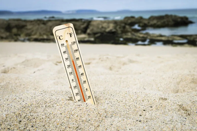 thermometer on the beach marking high temperatures climate change global warming ecological problems of the planet