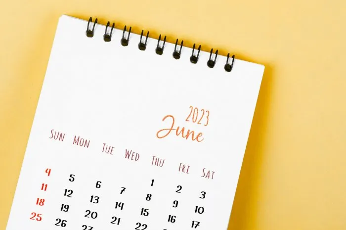 the june 2023 monthly desk calendar for 2023 year on yellow background