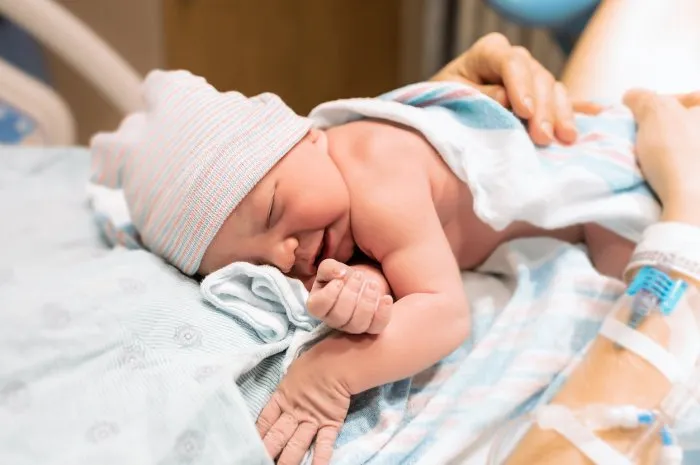 mother holding her newborn baby in the hospital