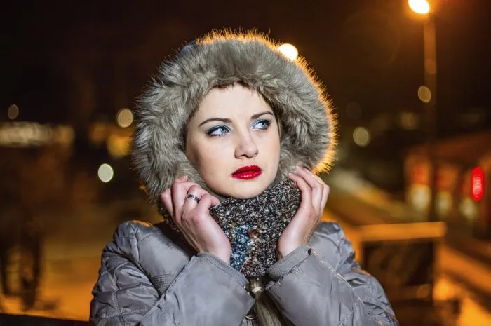 beautiful woman walking through the city on a cold winter night