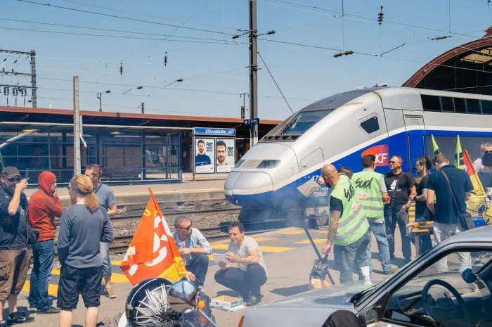 strasbourg, france - june 6, 2016  protesters making barbeque outside the gare de strasbourg, during a demonstration by railway workers of french state rail operator sncf, as part of a strike to defend their work conditions