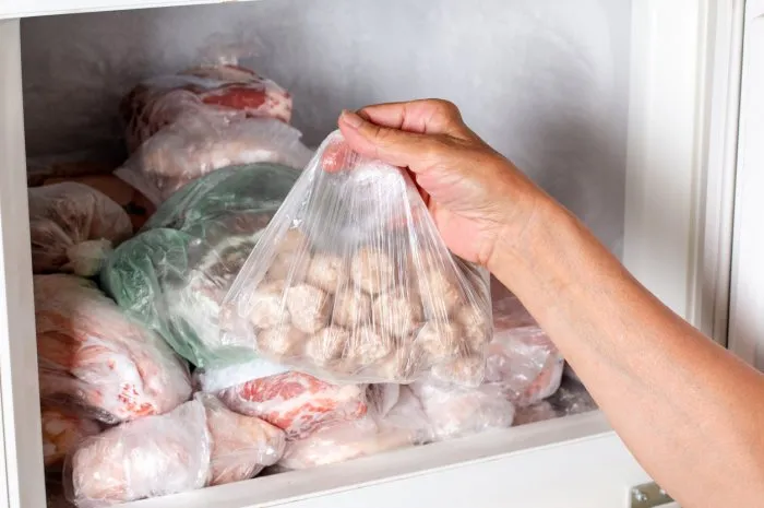 frozen food in the refrigerator plastic bag with meatballs in refrigerator, closeup