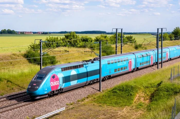champdeuil, france - june 1, 2022  a tgv duplex ouigo high speed train from french rail company sncf is driving to paris on the lgv sud-est in the countryside