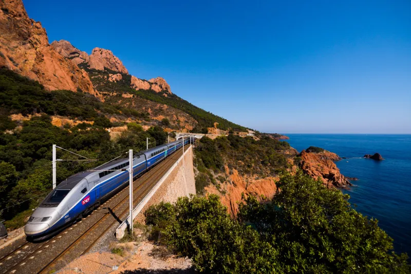 anthéor, france, september 27, 2014   a french high speed train tgv running over a viaduct alongside mediterranean coast
