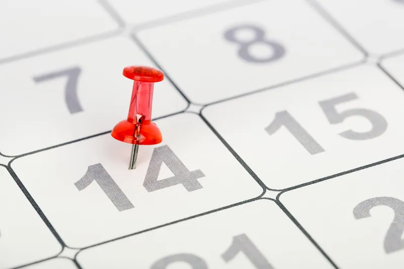 closeup of pushpin pinned on the fourteenth of the month