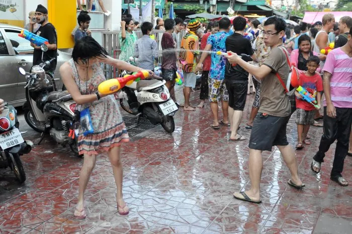 bangkok, thailand - april 13, 2012  revellers participate in a water fight in celebrating the thai new year on a city street in the thai capital the new year celebrations are held from 13 to 15 april