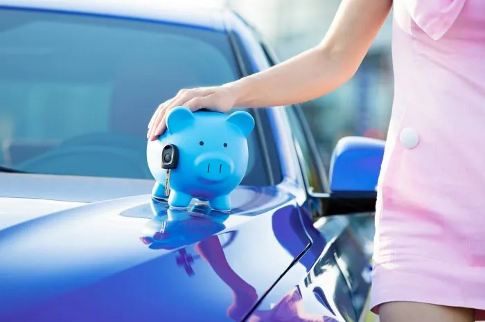 cropped image woman customer, agent and new car, piggy bank, key on hood, isolated outside, outdoors dealership offering credit line, finance services lease, automobile purchase, financing concept