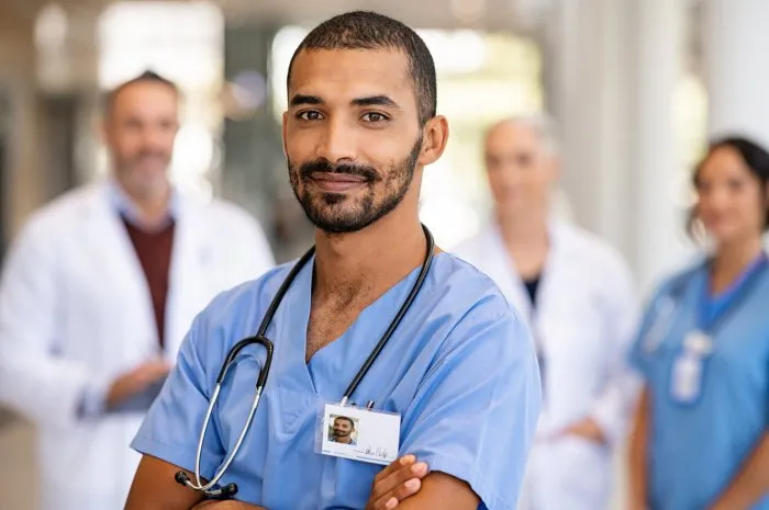 young confident male nurse looking at camera