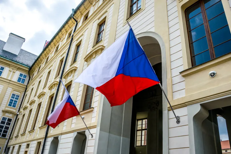 state flags of the czech republic at the entrance to the building of the president of the czech republic