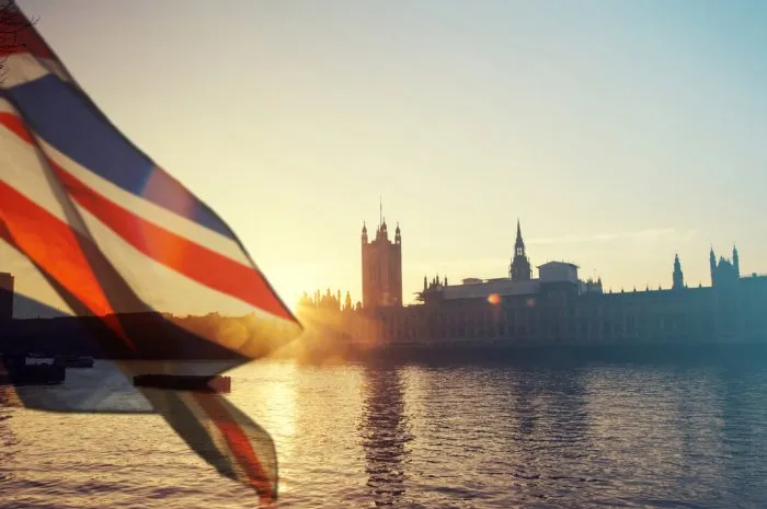 british union jack flag and big ben clock tower and parliament house at city of westminster in the background - uk votes to leave the eu, brexit concept