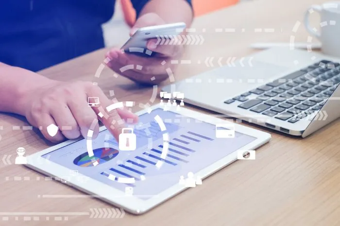 close up businessman hand typing or working on tablet and laptop and holding smartphone for programming about cyber security , advance future technology concept