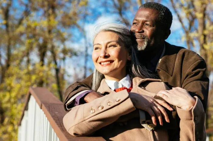 storytelling image of a multiethnic senior couple in love - elderly married couple dating outdoors, love emotions and feelings