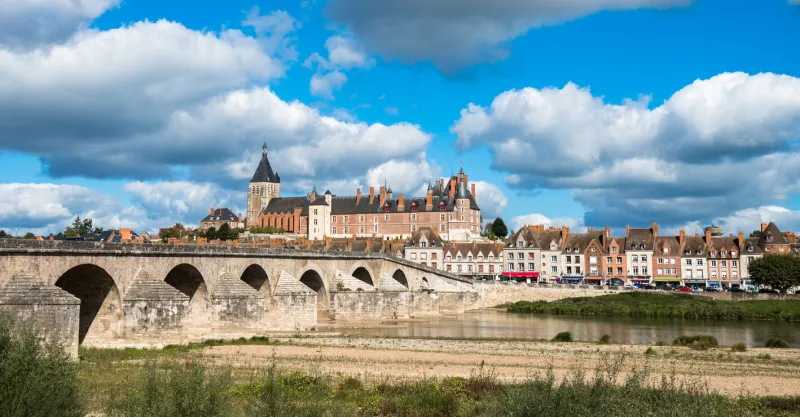 view of gien with the castle and the old bridge across the loire river, france