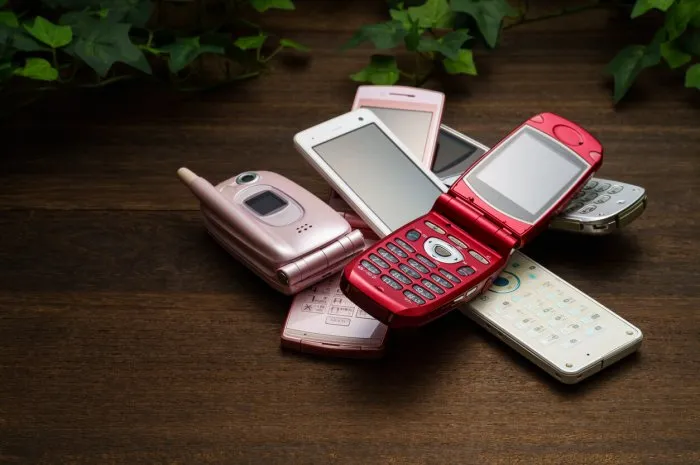 old used cell phone on white background