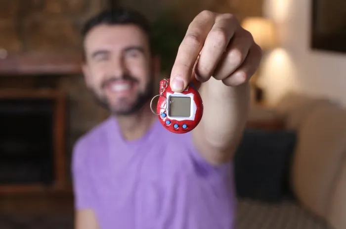nostalgic man holding 1990s video game
