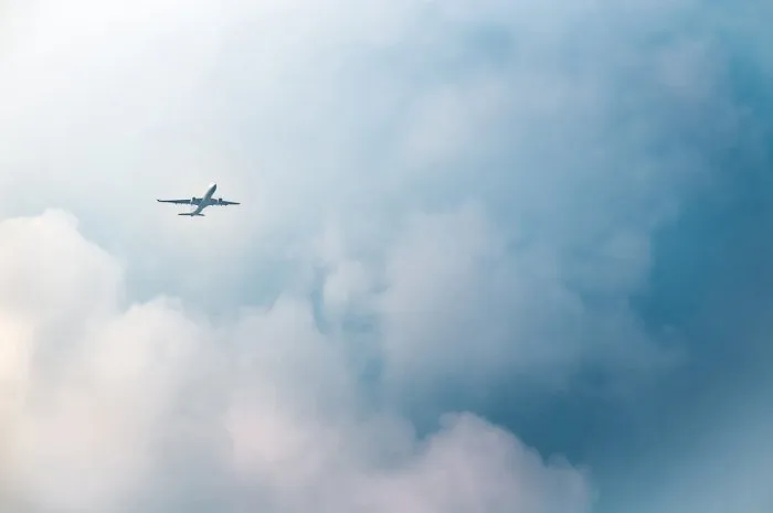 passenger airplane in the clouds