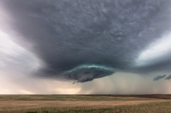 dramatic storm clouds from a supercell thunderstorm over a field near sidney, montana, usa