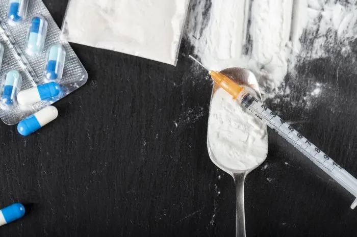 substance abuse hard drugs on dark table top view