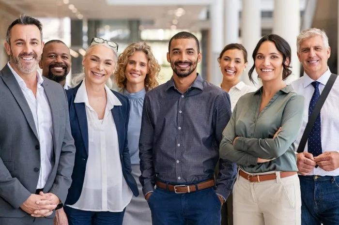 portrait of successful group of business people at modern office looking at camera portrait of happy businessmen and satisfied businesswomen standing as a team multiethnic group of people smiling and looking at camera