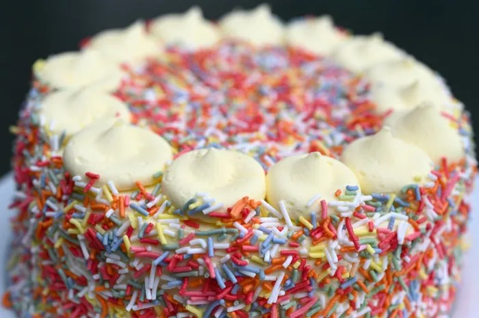 rainbow cake served served on rainbow theme party