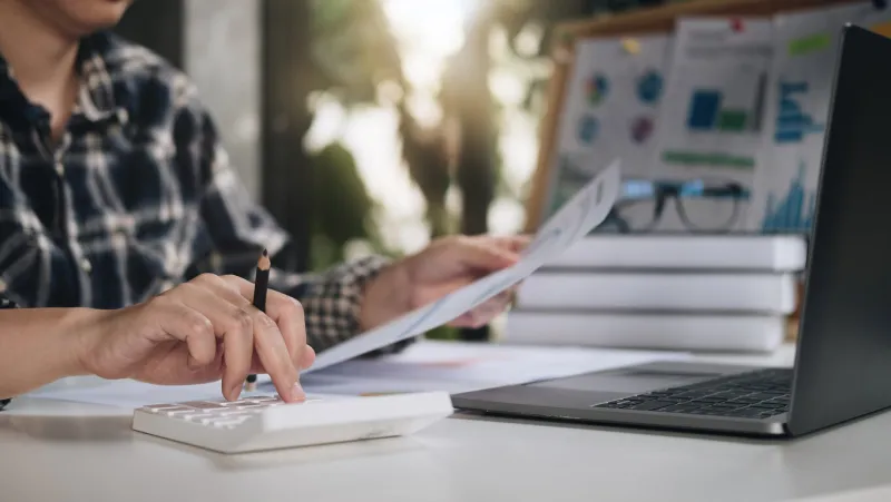 close up of woman calculate on calculator manage family budget make payment on computer female busy take care of household expenses expenditures, paying bills on laptop online saving concept