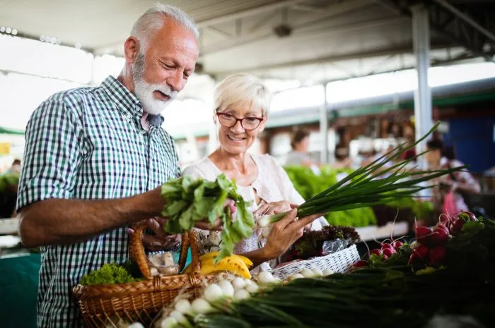 mature couple shopping vegetables and fruits on the market healthy diet