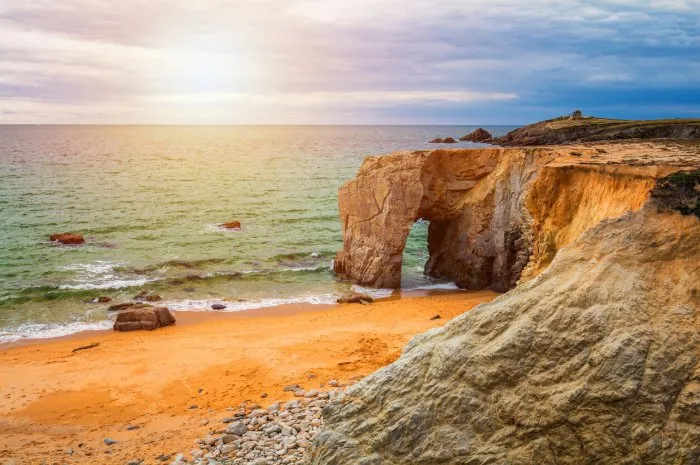 spectacular natural cliffs and stone arch arche de port blanc and beautiful famous coastline, brittany (bretagne), france, europe