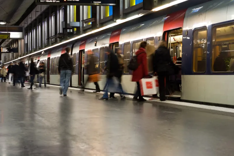busy weekend commuters board an rer train the paris rer trains link to the city's metro network note that two advertisements and one woman's face have been removed long shutter speed implies motion and activity