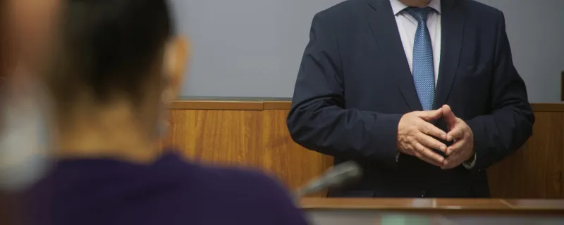 a politician, lawyer or pedagogue gives a speech to people the concept of public speaking by an authoritative or empowered person selective focusing no face