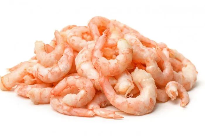 pile of boiled peeled shrimps isolated on white