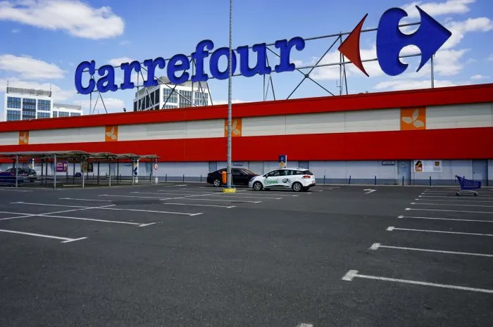 bucharest, romania - april 23, 2020  empty parking lot of french multinational retailer carrefour is seen at the orhideea shopping center in bucharest romania is in lockdown due to coronavirus