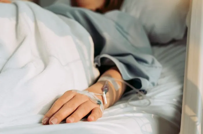 asian woman lying sick in hospital