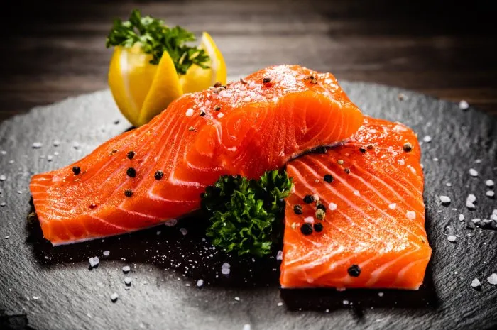 fresh raw salmon steak on cutting board