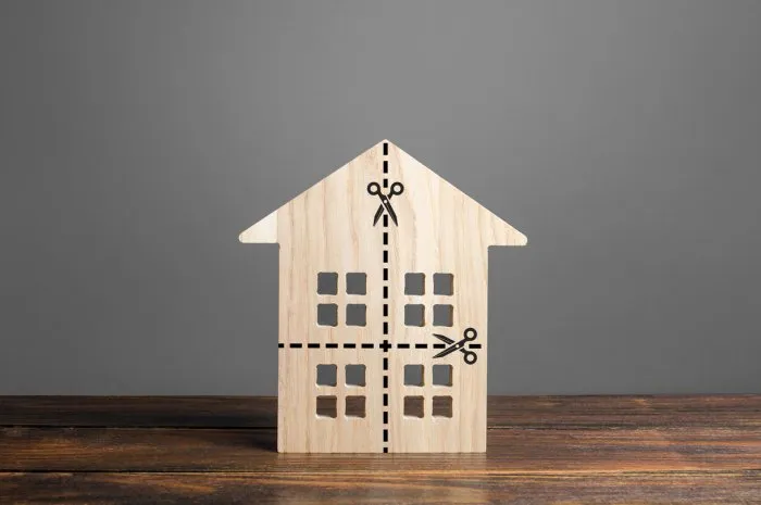 residential building divided by a dotted line into four equal parts distribution of the right divorce concept disputes over division process of real estate and property after divorce