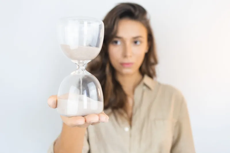 young woman holding an hourglass aging in lisbon, lisbon, portugal