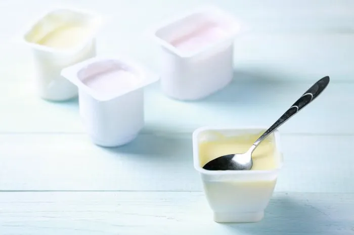 fresh youghurt in plastic pack on table closeupcolorful yogurtslight snack