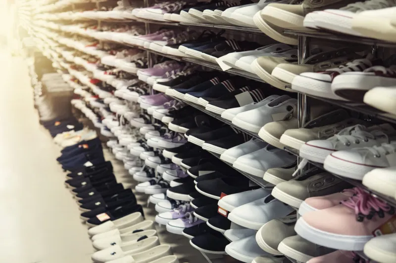 big collection of different sport shoes the shop window is filled with a large number of sports shoes of different colors men's women's shoes unisex