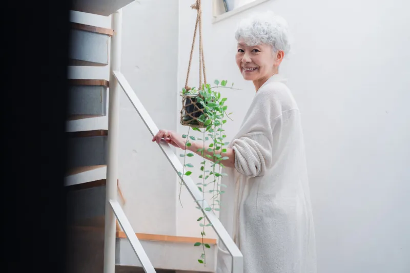 senior woman walking up and down stairs in good spirits