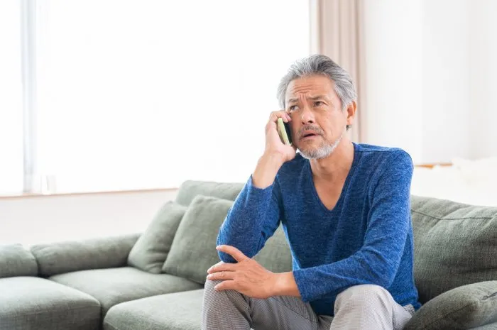 asian elderly man who talks on the telephone,think