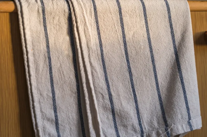 kitchen towel hanging from the wooden door in the morning, close up