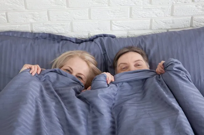 sensual mature couple together in bed happy couple in bedroom enjoying sensual foreplay selective focus