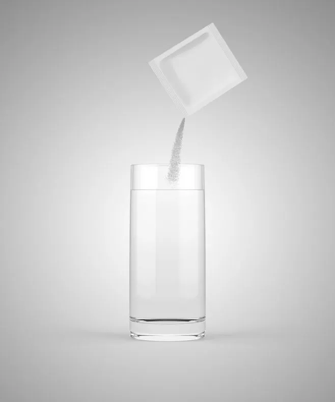 pouring powdered medicine into glass of water