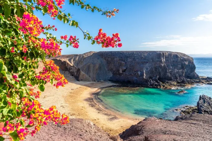 landscape with turquoise ocean water on papagayo beach, lanzarote, canary islands, spain