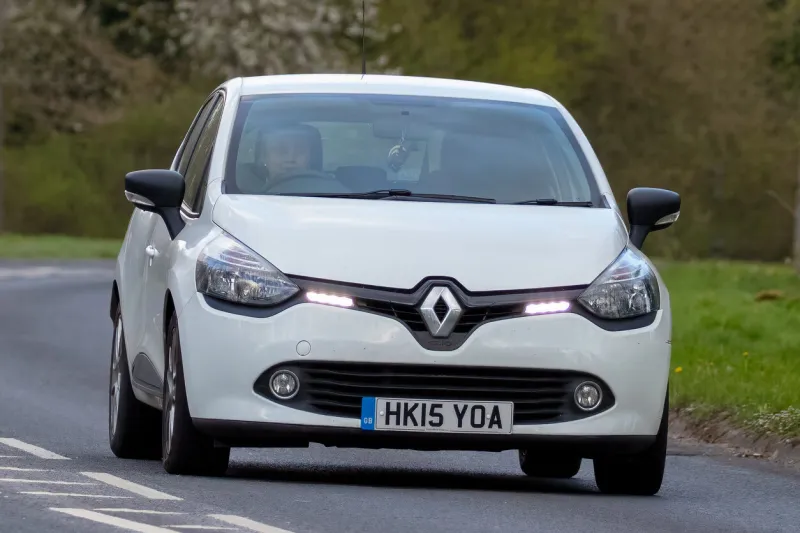 milton keynes,bucks,uk - april,13th 2022 2015 white renault clio car travelling on an english country road