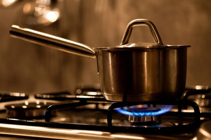 pan on a gas burner in a kitchen