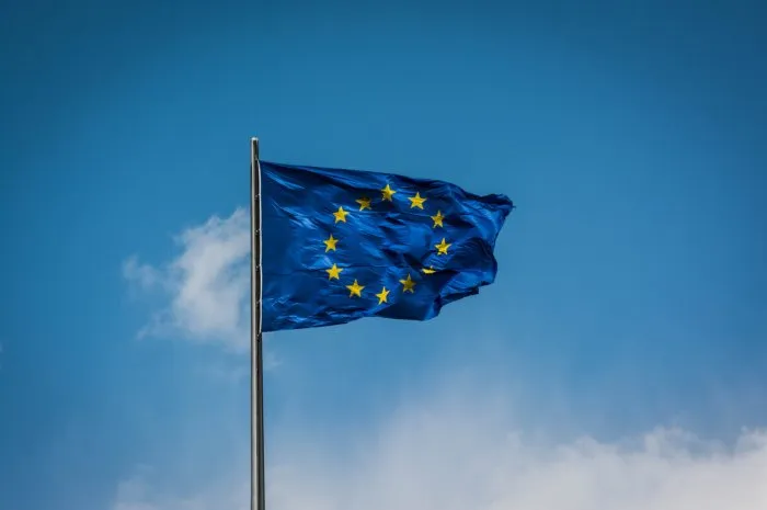 the european flag fluttering in the wind with a blue sky background