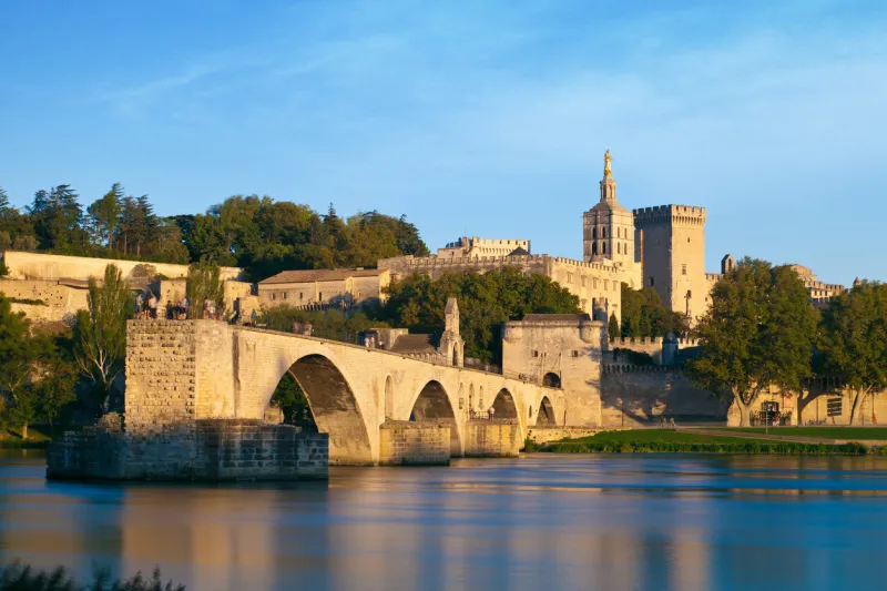 avignon bridge with popes palace and rhone river at sunrise, pont saint-benezet, provence, france