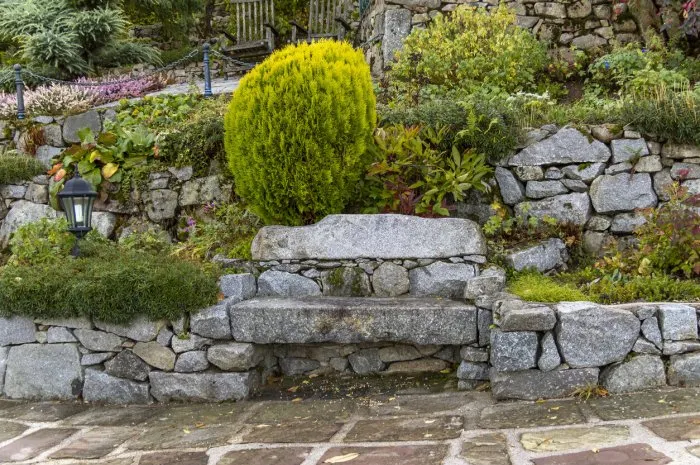 idyllic garden scenery including a stone bench seen in france