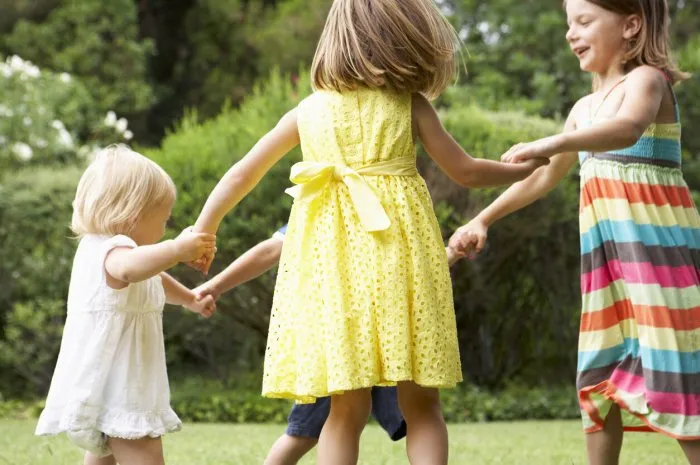 group of children playing outdoors together having fun